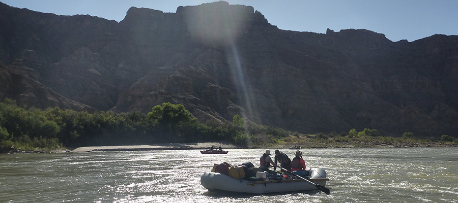 researchers in two inflatable rafts on canyon river