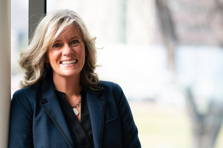 Brenda Bowen, smiling, wearing a dark blue suit jacket.